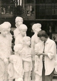 Marie Uchytilová's daughter, Sylvia Klánová, by the sculptures (1980s]