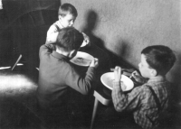Evžen Adámek on the photograph during his childhood at a Sunday dinner with his brothers, Josef and Stanislav 