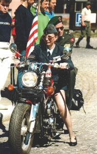 Here, Iveta's heritage shows in full - as a part  convoy of jeeps which followed the demarcation line, with a colleague from the U. S. army who sat all the way long behind her and with the U. S. flag, they were the last in the convoy. Stříbro, 2003