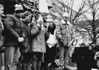 Monika Brázdová speaks into a mic at a demonstration at Horní náměstí (a square) in the town of Humpolec on the day of the general strike November 27, 1989