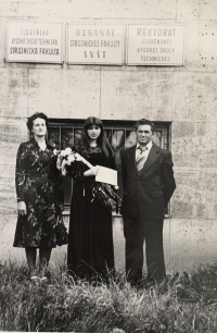 Helena Aková with husband and daughter during graduation ceremony