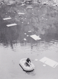 Olaf Hanel floating in a boat in the middle of a flooded quarry. One of his land art events called Burning of the Ponds of František Charamza and Sons, Lipnice nad Sázavou (1972)