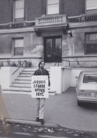 Olaf Hanel in front of the Czechoslovak Embassy in Canada with a protest banner supporting the release of dissidents, 1989
