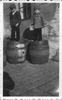Marián Hošek with brother Jozef on barrels in a brewery, 1954