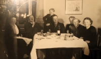 Family gathering during Christmas. Witness's father Stanislav Zedníček at the head, with mother Emilie seated second right, and grandmother Anna behind her