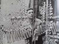 Ladislav Oliva is photographed at the outdoor banner for the Obora exhibition Glass 67 in Prague's Old Town Hall. His design was realized by the Bohemia Glassworks in Poděbrady.