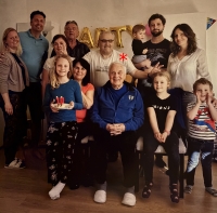Jiří Petz (in blue jacket, bottom centre) with his family, 2025