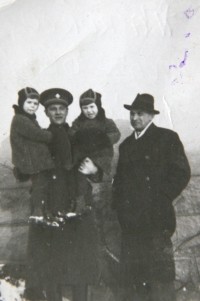 The twins being held by Mr. Růžička, tenant in the Faltus house, and Mr. Faltus, the girls' father
