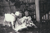 Zděnka and her twin sister Eva with goat and a dog