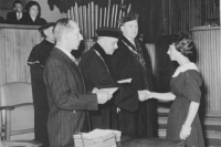 Zděnka's graduatin ceremony in December 1961. Professor Hrůza is shaking her hand and handing her the diploma, Rector Kudrna is standing on his left.