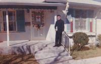 1963 - San Antonio, Texas: "This photo is of me taken at Christmas. It is the house of a Polish family, where I was at lunch. On the door is a package on the windows the candles. It's a christmas decoration. See it's mainly in the evening when it is illum