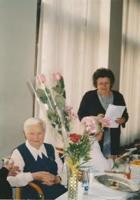 Kristina, with a sheet of paper in her hand, as a chairwoman of the Association of Ukrainian Women in Prague in 2003