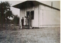 Soukup family in front of their temporary home